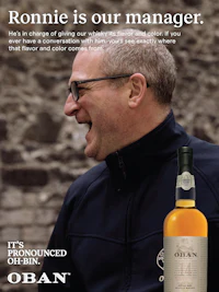 a man is holding a bottle of whisky