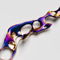 a piece of jewelry with a rainbow colored liquid on it